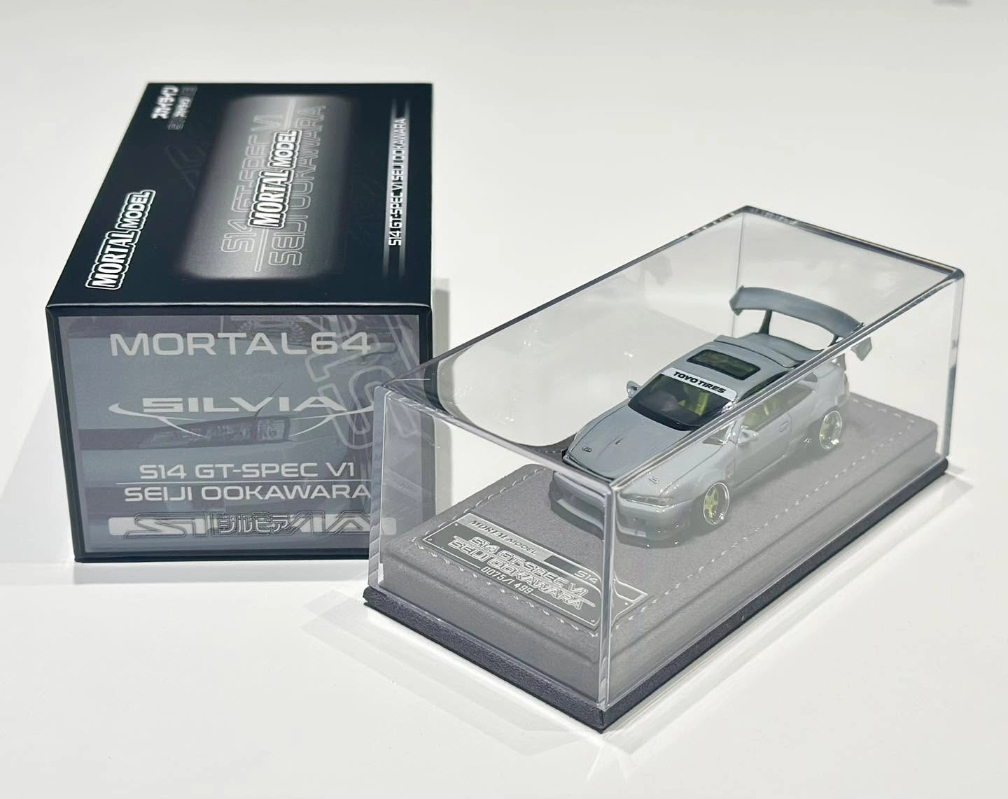 Mortal Model HEC 2026 Event Special 1/64th Nissan Silvia S14 GT-Spec V1 Seiji Ookawara in Cement Grey. Limited 499pcs with display case.